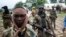 FILE - Seleka fighters stand in their base before a mission in the town of Lioto, Central African Republic, June 9, 2014.