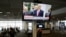 President Donald Trump is pictured on a television at Seattle-Tacoma International Airport as he declares a national emergency over the coronavirus, in SeaTac Washington, March 13, 2020. 