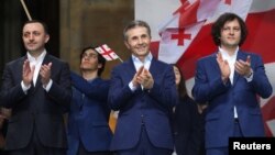 在格鲁吉亚首都第比利斯，格鲁吉亚总理伊拉克利·科巴希泽（右）、前总理兼格鲁吉亚梦想党主席伊拉克利·加里巴什维利（左）和前总理兼格鲁吉亚梦想党创始人比季娜·伊万尼什维利参加支持“外国代理人”法案的亲政府集会。（2024年4月29日）