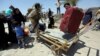 Displaced Sunni people fleeing the violence in the city of Ramadi arrive at the outskirts of Baghdad, May 16, 2015.