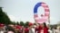FILE - David Reinert holding a Q sign waits in line with others to enter a campaign rally with President Donald Trump in Wilkes-Barre, Pa. 