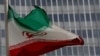 FILE - An Iranian flag flutters in front of the International Atomic Energy Agency headquarters in Vienna, Austria, Sept. 9, 2019.