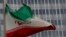 FILE - An Iranian flag flutters in front of the International Atomic Energy Agency headquarters in Vienna, Austria, Sept. 9, 2019.