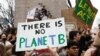 FILE - Students hold placards during a demonstration against climate change at Columbus Circle in New York, March 15, 2019. 
