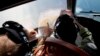 Flight Lt. Jayson Nichols looks at a map as he flies aboard a Royal Australian Air Force AP-3C Orion aircraft during a search operation of the missing Malaysian Airlines flight MH370 over the southern Indian Ocean, March 27, 2014. 