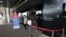 FILE - A masked man walks out of an area of the scan at the quiet Phnom Penh International Airport in Phnom Penh, Cambodia, Friday, April 3, 2020. 