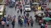 Rice farmers walk between their tractors on a main highway where they spent a night in Ayutthaya. Thai farmers called off a tractor drive to Bangkok's main airport to protest against not being paid under a rice subsidy scheme after an assurance they would