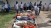 Somalis observe bodies that were brought to and displayed at a Mogadishu hospital, Aug. 25, 2017. 