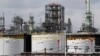 FILE - Storage tanks are shown at a refinery in Detroit, April 21, 2020.