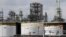 FILE - Storage tanks are shown at a refinery in Detroit, April 21, 2020.
