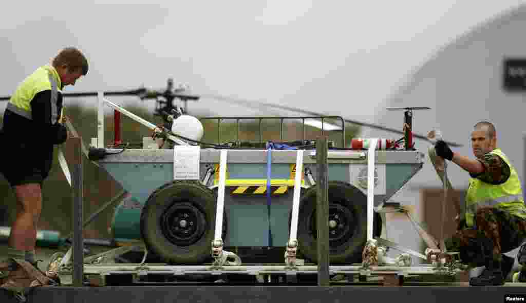 A New Zealand soldier secures a robot from Australia onto a truck at Hokitika airport on New Zealand&#39;s west coast, Nov. 24, 2010. The robot will be used to assist the rescue effort of 29 miners trapped underground after an explosion at the nearby Pike River coal mine. (Reuters)