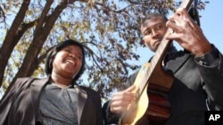 Singer Bertha Matthews and guitarist Sipho Dube make their living playing for money in the streets of Soweto, where a lot of development is bringing tourists into the famous township