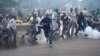 Protesters, rallying against what they see as a biased electoral commission, run away from police during clashes in Nairobi, Kenya, May 16, 2016. The country is scheduled to hold presidential and parliamentary elections in August 2017.