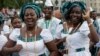 Singers of "Lagos City Chorale" choir of Nigeria greet people during the 2014 World Choir Games parade of nations in Riga, Latvia, July 15, 2014.
