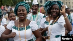 Singers of "Lagos City Chorale" choir of Nigeria greet people during the 2014 World Choir Games parade of nations in Riga, Latvia, July 15, 2014.