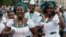 Singers of "Lagos City Chorale" choir of Nigeria greet people during the 2014 World Choir Games parade of nations in Riga, Latvia, July 15, 2014.