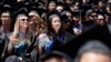 Graduates listen to U.S. President Barack Obama (not pictured) talk during the commencement ceremony for the University of California, Irvine at Angels Stadium in Anaheim, California June 14, 2014. 