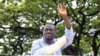 Opposition leader Kizza Besigye waves to his supporters prior to his arrest at gunpoint in late April.
