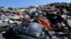 FILE - Piles of life jackets used by refugees and migrants lie at a dump in Molyvos village, near Lesbos, Greece. The Minnesota-based company Epimonia uses the life jackets to make bracelets that are sold to raise funds to help refugees and immigrants.