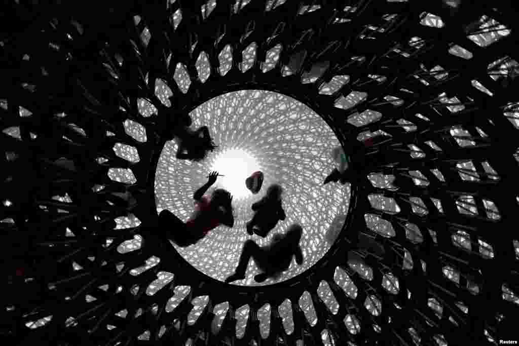 Children play inside the Hive, designed by artist Wolfgang Buttress, at Kew Gardens, in London, July 1, 2017.