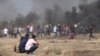 Crowds cheer as young men pull down the fence on this section of the Gaza/Israel border and rush across, May 14, 2018. 