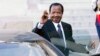 FILE - Cameroon President Paul Biya waves to reporters as he gets into his car after a meeting at the Elysee Palace, in Paris, May 17, 2014.