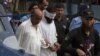 Police escort blindfolded Muslim cleric Khalid Jadoon on suspicion of framing Christian girl Rimsha Masih who was arrested under the country's controversial anti-blasphemy, September 2, 2012.