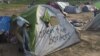 Many of the tens of thousands of refugees in Idomeni, Greece, have been camping by the border for more than a month, and still hope to pass through Macedonia into Western Europe, March 30, 2016. (H. Murdock/VOA)