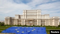 FILE - A large European Union flag is displayed in front of Romania's Parliament Building to mark EU Day in Bucharest, May 9, 2013. 