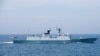 FILE - A Chinese naval helicopter prepares to land aboard the People's Liberation Army frigate CNS Huangshan in the South China Sea, June 16, 2017.