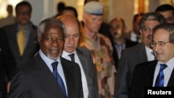 Syria's Deputy Foreign Minister Faisal al-Miqdad (R) welcomes U.N.-Arab League envoy Kofi Annan at a hotel in Damascus, July 8, 2012.