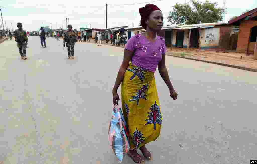 French soldiers of the Sangaris operation escort a Muslim woman after she was attacked by anti-Balaka rebels while shopping outside the mosque of the PK12 district, Bangui, Central African Republic.