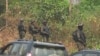 FILE - The military stands guard as government officials visit Lebialem, in southwest Cameroon, Sept. 15, 2018. Three village chiefs from Lebialem were murdered Feb. 13, 2021, by suspected rebels. 