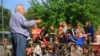 "Reverend Jim Lavender, Jr. gives a children's Bible sermon at a church parking lot using rescued circus animals, in Centreville, Virginia on May 4, 2013." (Jill Craig/VOA) 