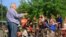 "Reverend Jim Lavender, Jr. gives a children's Bible sermon at a church parking lot using rescued circus animals, in Centreville, Virginia on May 4, 2013." (Jill Craig/VOA) 