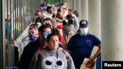 Hundreds of people line up outside a Kentucky Career Center hoping to find assistance with their unemployment claim in Frankfort, Kentucky, U.S. June 18, 2020. 