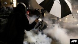 2021年4月12日，明尼苏达州明尼阿波利斯市布鲁克林中心，人们在布鲁克林中心警察局外，躲避警察的燃放催泪瓦斯。