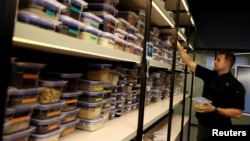 Bernardo Moltedo, scientist in the IA area of the plant-based food company NotCo, selects spices used for their recreated veggie-based turtle soup, developed with AI at the NotCo kitchen-laboratory, in Santiago, Chile, April 19, 2024. (REUTERS/Ivan Alvarado)