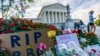 People gather at the Supreme Court on the morning after the death of Justice Ruth Bader Ginsburg, 87, Sept. 19, 2020 in Washington. 