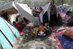 Internally displaced Afghans from northern provinces, who fled their home due to fighting between the Taliban and Afghan security personnel, take refuge in a public park Kabul, Afghanistan, Aug. 13, 2021.