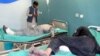 Afghan men receive treatment at a hospital after a suicide car bomber and gunmen attacked a provincial Afghan police headquarters in Gardez, the capital of Paktia province, Afghanistan, Oct. 17, 2017. 