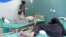 Afghan men receive treatment at a hospital after a suicide car bomber and gunmen attacked a provincial Afghan police headquarters in Gardez, the capital of Paktia province, Afghanistan, Oct. 17, 2017. 