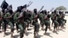 FILE - Newly trained al-Shabab fighters participate in military exercises in the Lafofe area, south of Mogadishu, in Somalia, Feb. 17, 2011. 