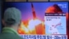 A man watches a TV screen showing a file image of North Korea's missile launch during a news program at the Seoul Railway Station in Seoul, South Korea, March 29, 2020.