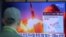 A man watches a TV screen showing a file image of North Korea's missile launch during a news program at the Seoul Railway Station in Seoul, South Korea, March 29, 2020.