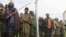 Congolese M23 rebel fighters gather inside an enclosure after surrendering to Uganda's government at Rugwerero village in Kisoro district, 489km (293 miles) west from Uganda capital Kampala, Nov. 8, 2013. 