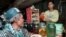 FILE PHOTO - A Cambodian customer waits for a glass of the popular local rice wine at a Phnom Penh street stall. (REUTERS)
