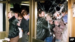 FILE - Protesters storm the headquarters building of the East German Stasi secret service in what was then East Berlin, Jan. 15, 2020.