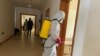 FILE - A health agent wearing protective equipment, disinfects the corridors amid the spread of the coronavirus disease (COVID-19), at an hospital in Douala, Cameroon, April 27, 2020. 