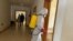 FILE - A health agent wearing protective equipment, disinfects the corridors amid the spread of the coronavirus disease (COVID-19), at an hospital in Douala, Cameroon, April 27, 2020. 